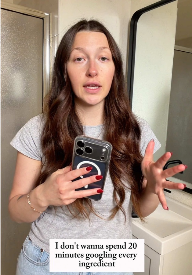 Ashley speaking to camera while holding a phone